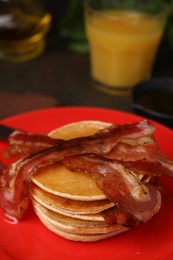 Photo of Delicious pancakes with bacon on table, closeup