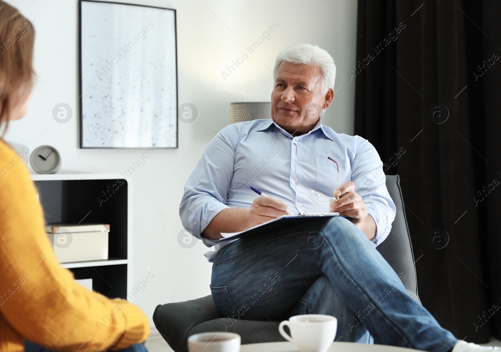 Photo of Professional psychotherapist working with patient in office