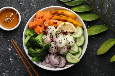 Photo of Bowl with many different vegetables and rice on grey textured table, flat lay. Vegan diet
