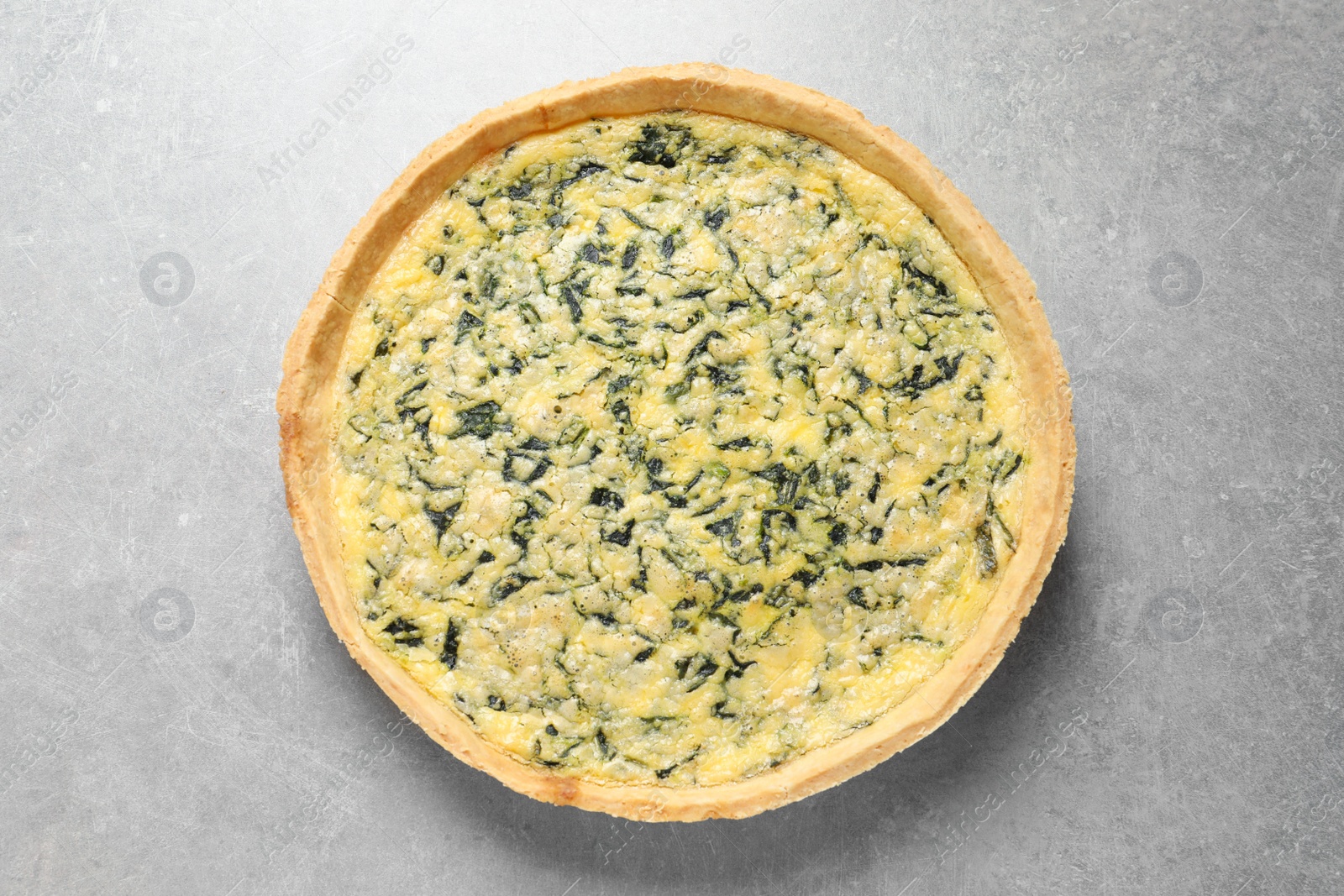 Photo of Delicious homemade spinach pie on light grey table, top view