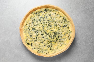 Delicious homemade spinach pie on light grey table, top view