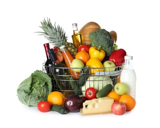 Shopping basket and grocery products on white background