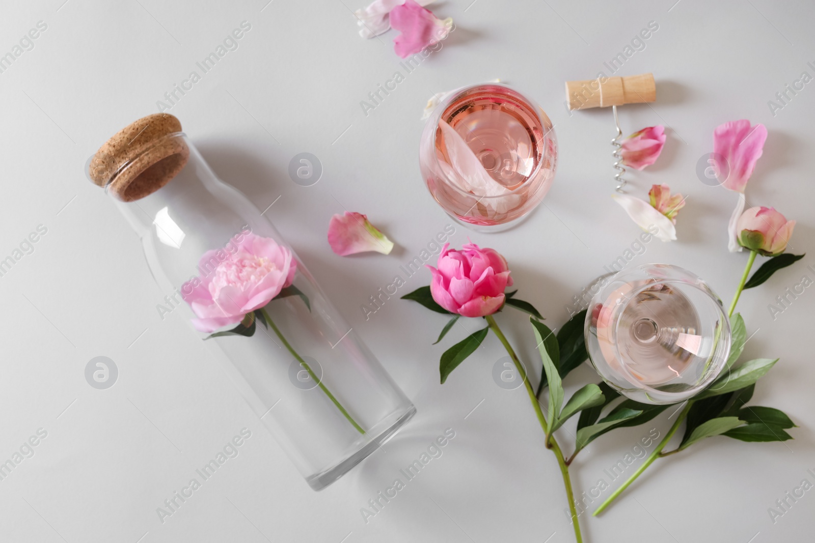 Photo of Flat lay composition with rose wine and beautiful pink peonies on white background