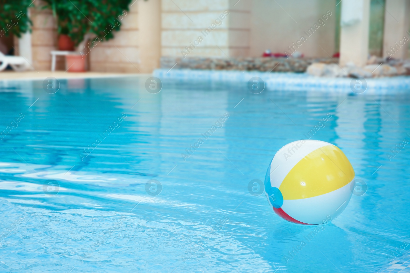 Photo of Colorful inflatable ball floating on water in swimming pool