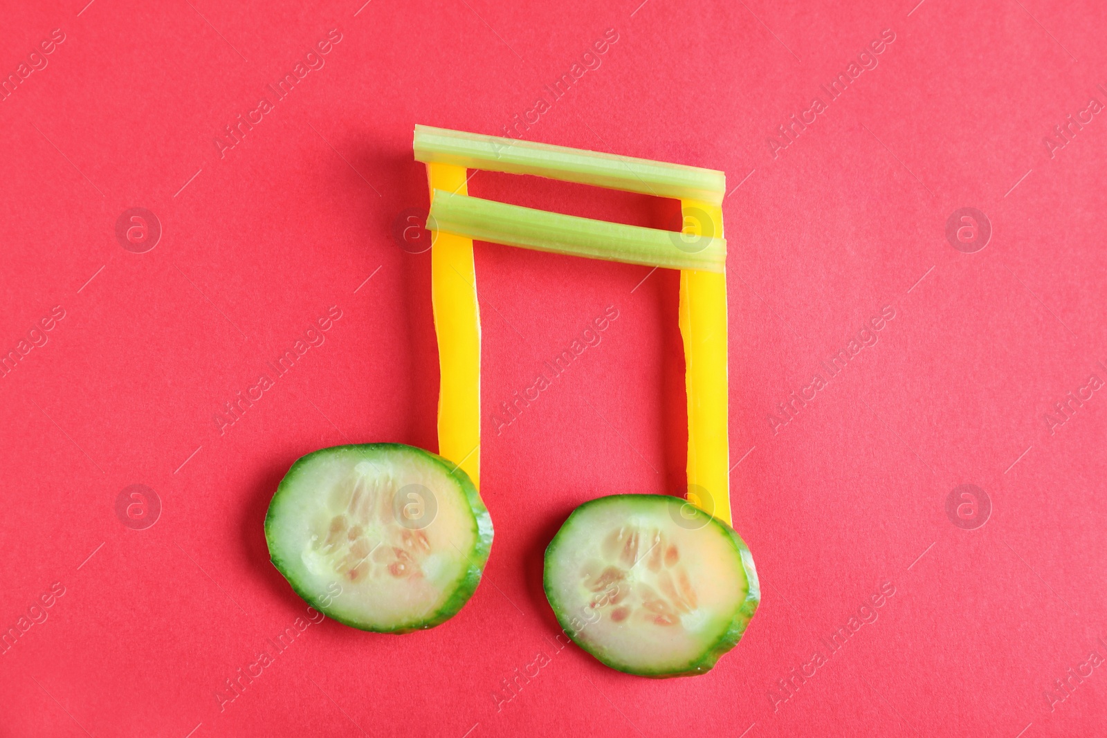 Photo of Musical note made of vegetables on color background, top view