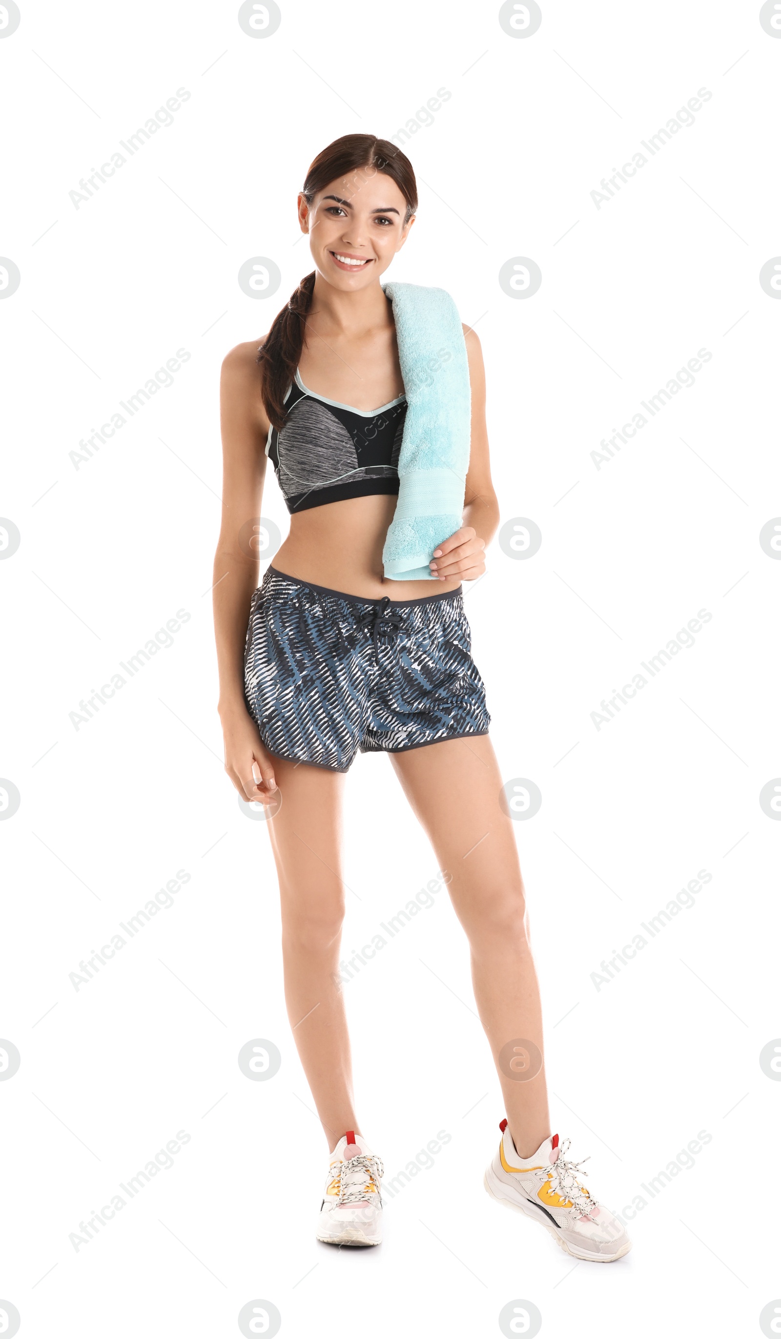 Photo of Beautiful young woman in sportswear with towel on white background