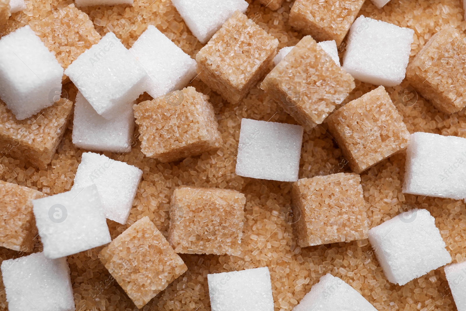 Photo of Different types of sugar as background, top view