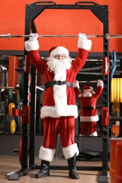 Photo of Authentic Santa Claus training in modern gym