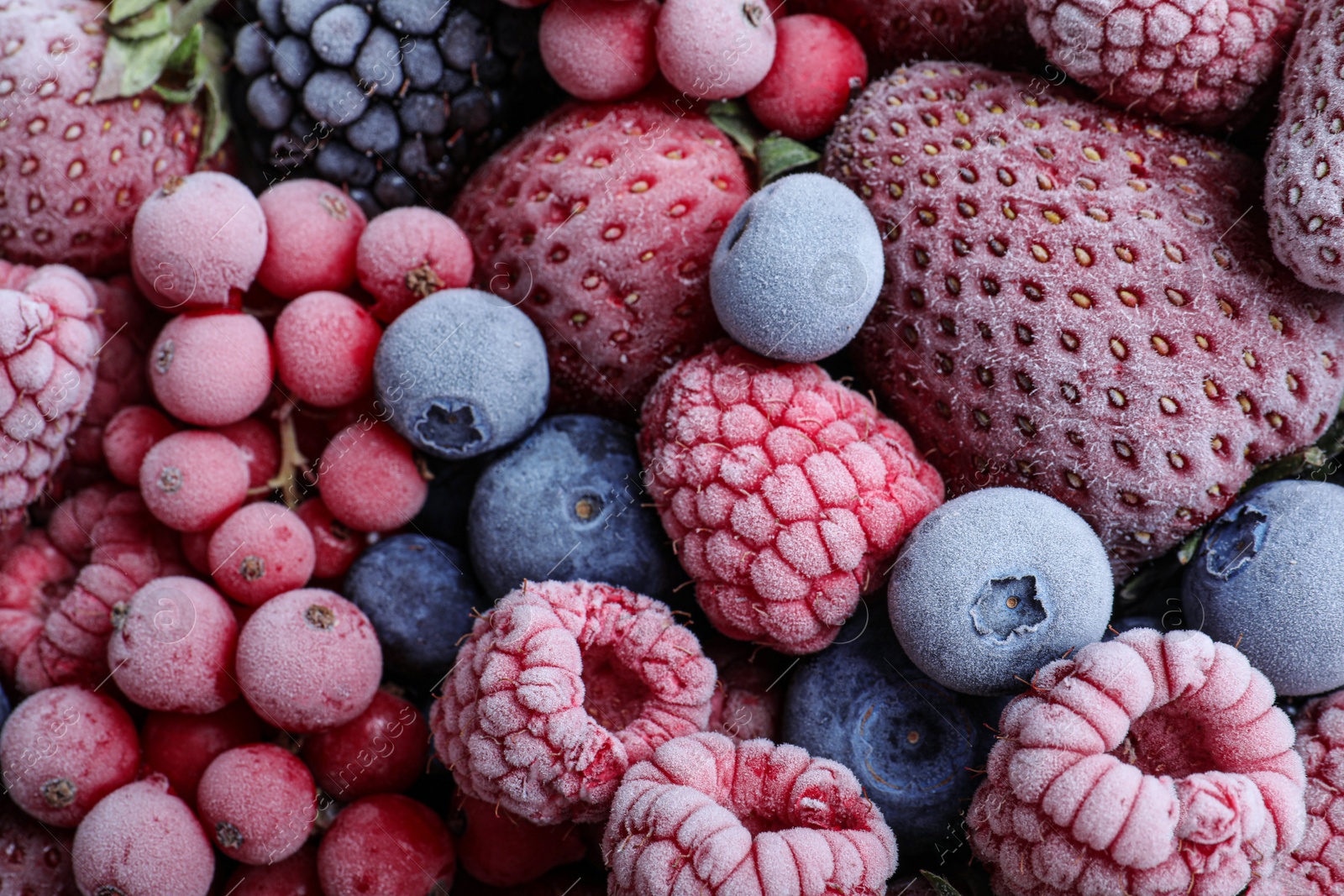 Photo of Mix of different frozen berries as background, top view