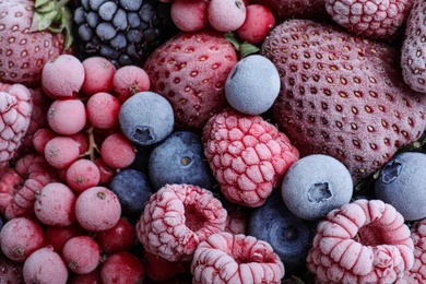 Mix of different frozen berries as background, top view