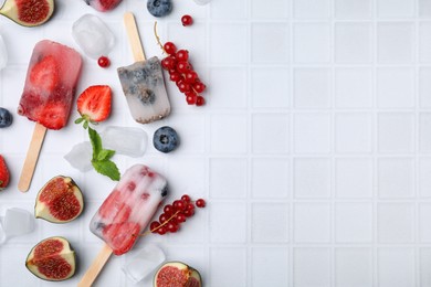 Photo of Flat lay composition with berry ice pops on white table. Space for text