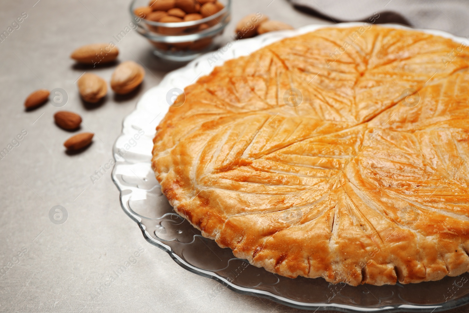 Photo of Traditional galette des rois on light grey table, closeup