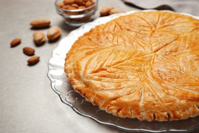 Traditional galette des rois on light grey table, closeup