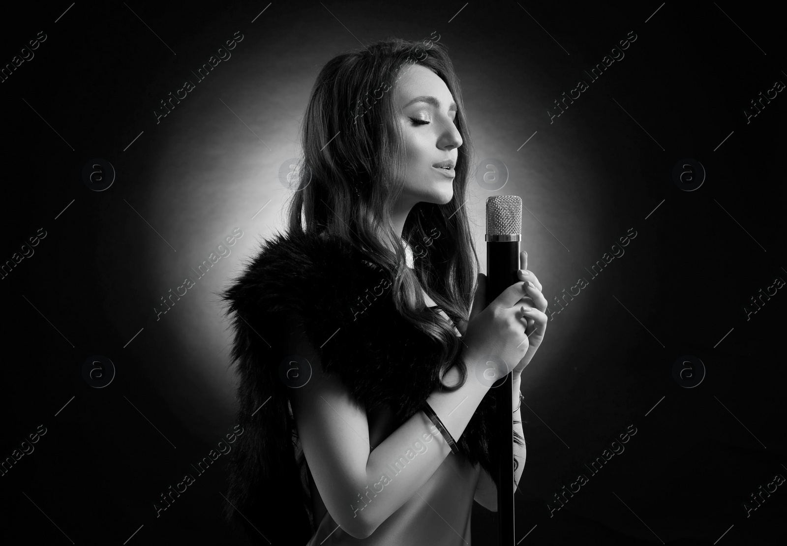 Image of Beautiful singer with microphone, black and white effect