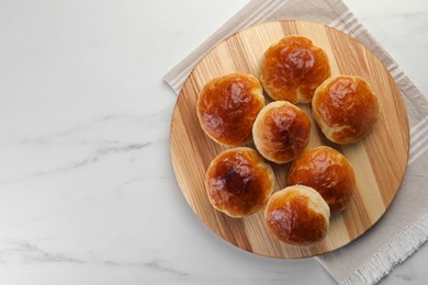 Tasty scones prepared on soda water on white marble table, top view. Space for text