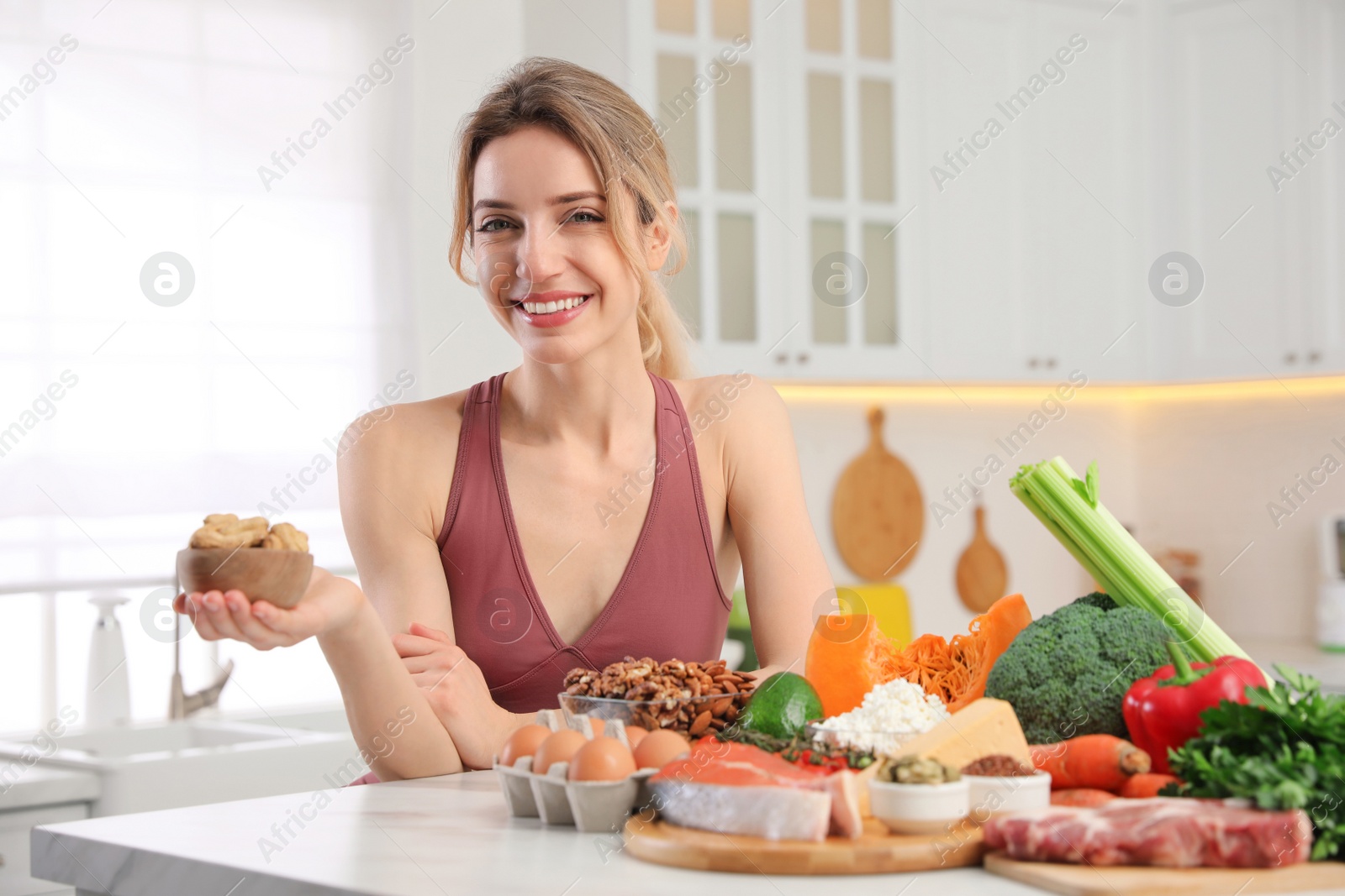 Photo of Woman with healthy food in kitchen. Keto diet