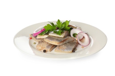 Plate with delicious salted herring slices, onion rings, peppercorns and parsley isolated on white