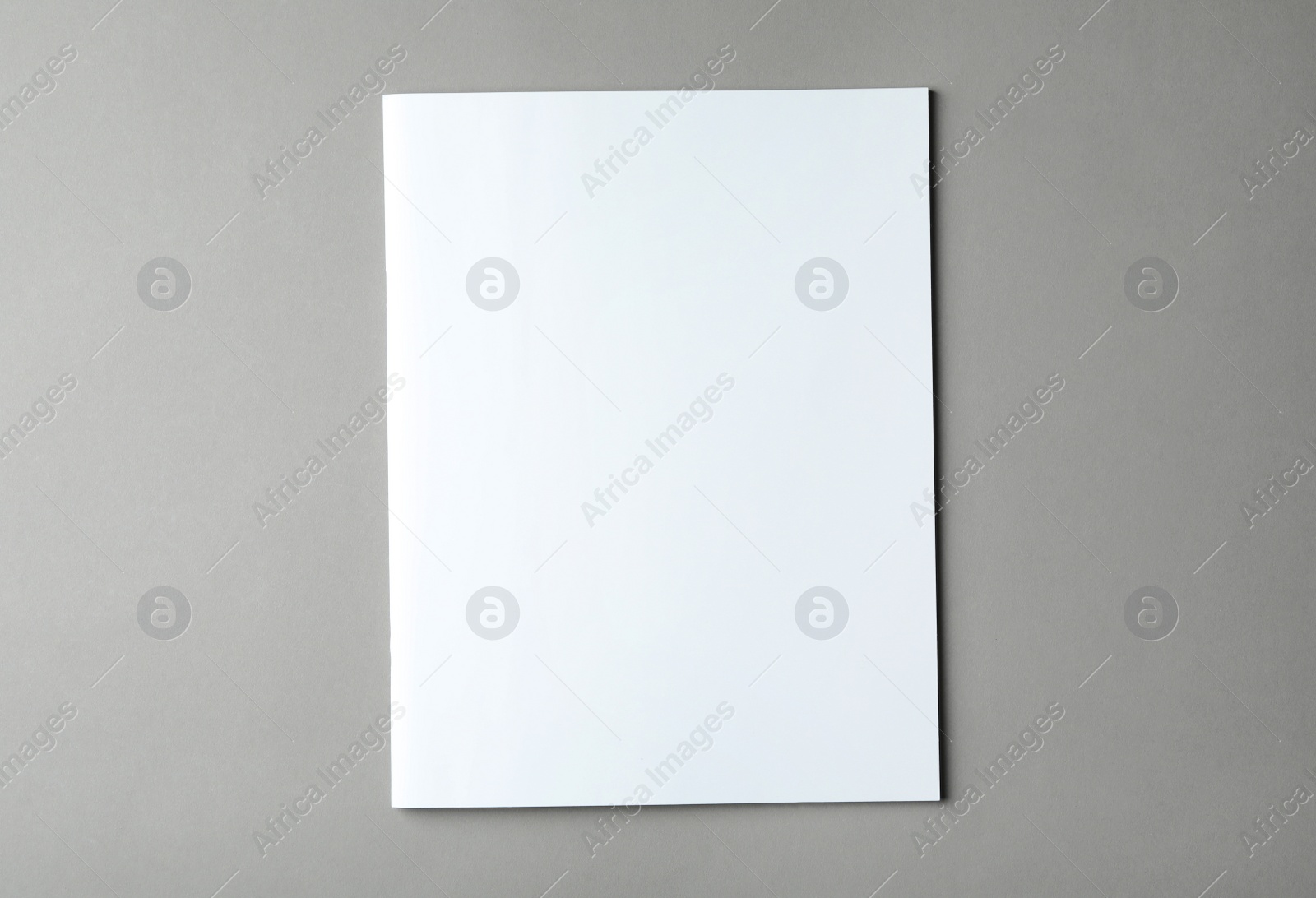 Photo of Brochure with blank cover on grey background, top view. Mock up for design