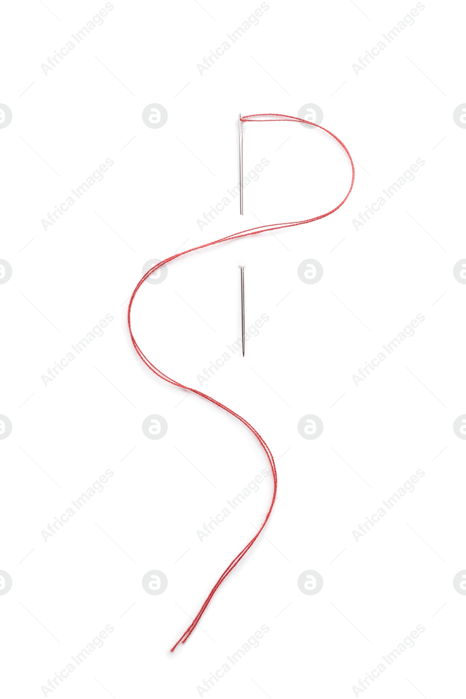 Photo of Sewing needle with red thread isolated on white, top view
