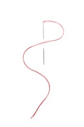 Sewing needle with red thread isolated on white, top view