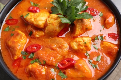 Photo of Bowl of delicious chicken curry, closeup view