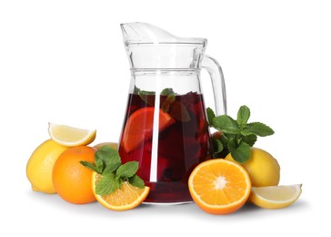 Photo of Jug with tasty punch drink and ingredients isolated on white