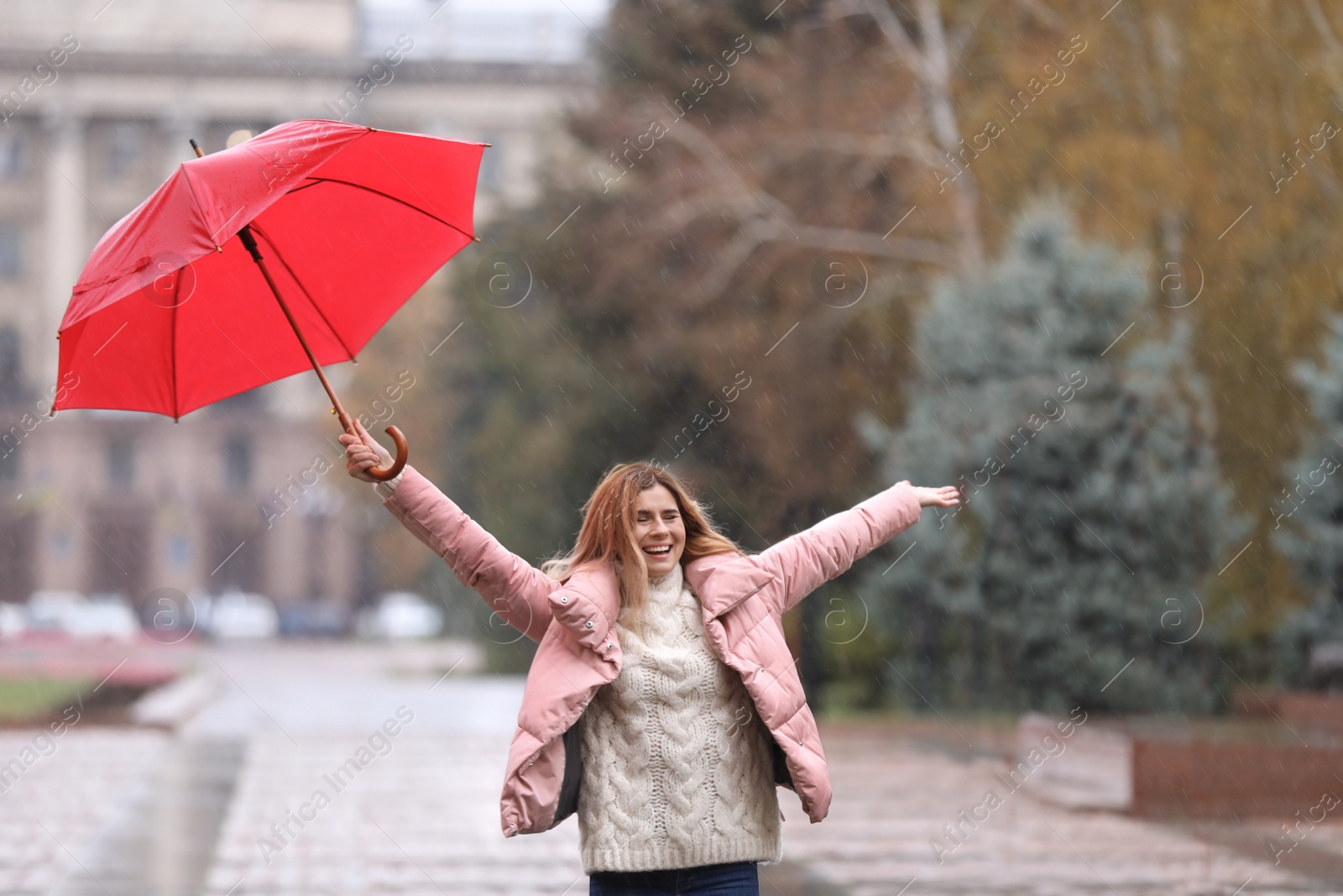 Photo of Woman with umbrella in city on autumn rainy day