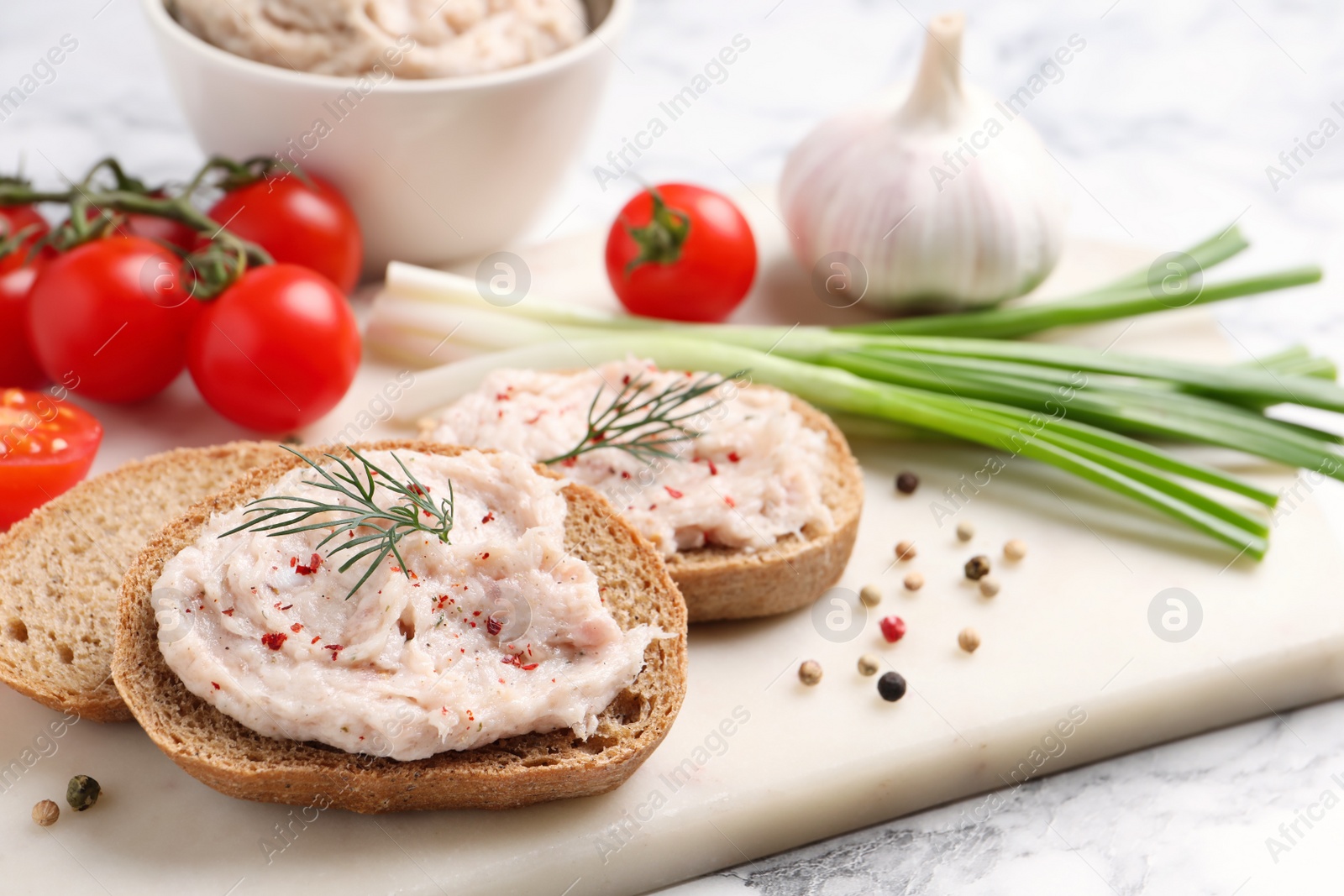 Photo of Sandwiches with delicious lard spread and vegetables on table