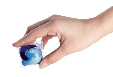 Woman holding laundry capsule on white background, closeup