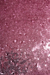Photo of Fabric with beautiful rose gold paillettes as background