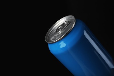 Blue can of energy drink on black background, closeup. Space for text