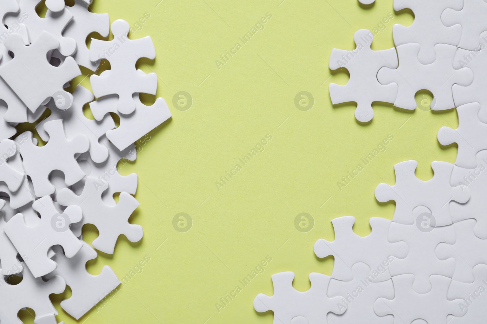 Photo of Blank white puzzle pieces on yellow background, flat lay