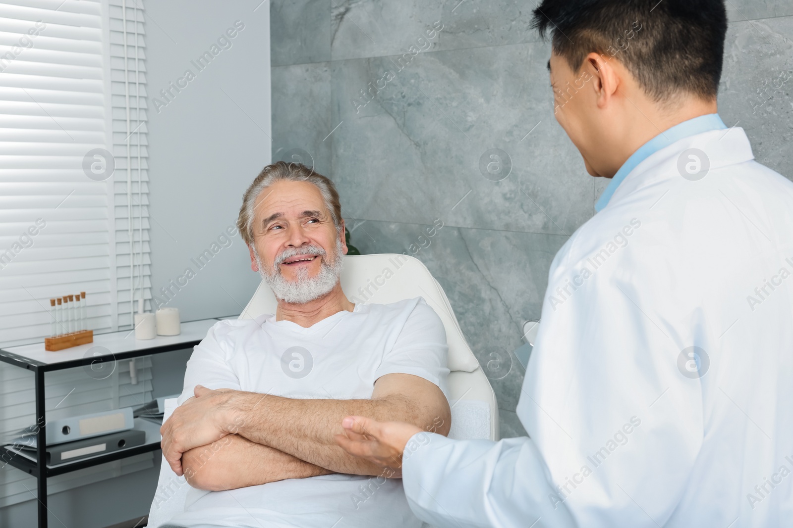 Photo of Senior patient having appointment with doctor in clinic