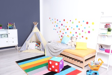 Modern child room interior with bed and play tent