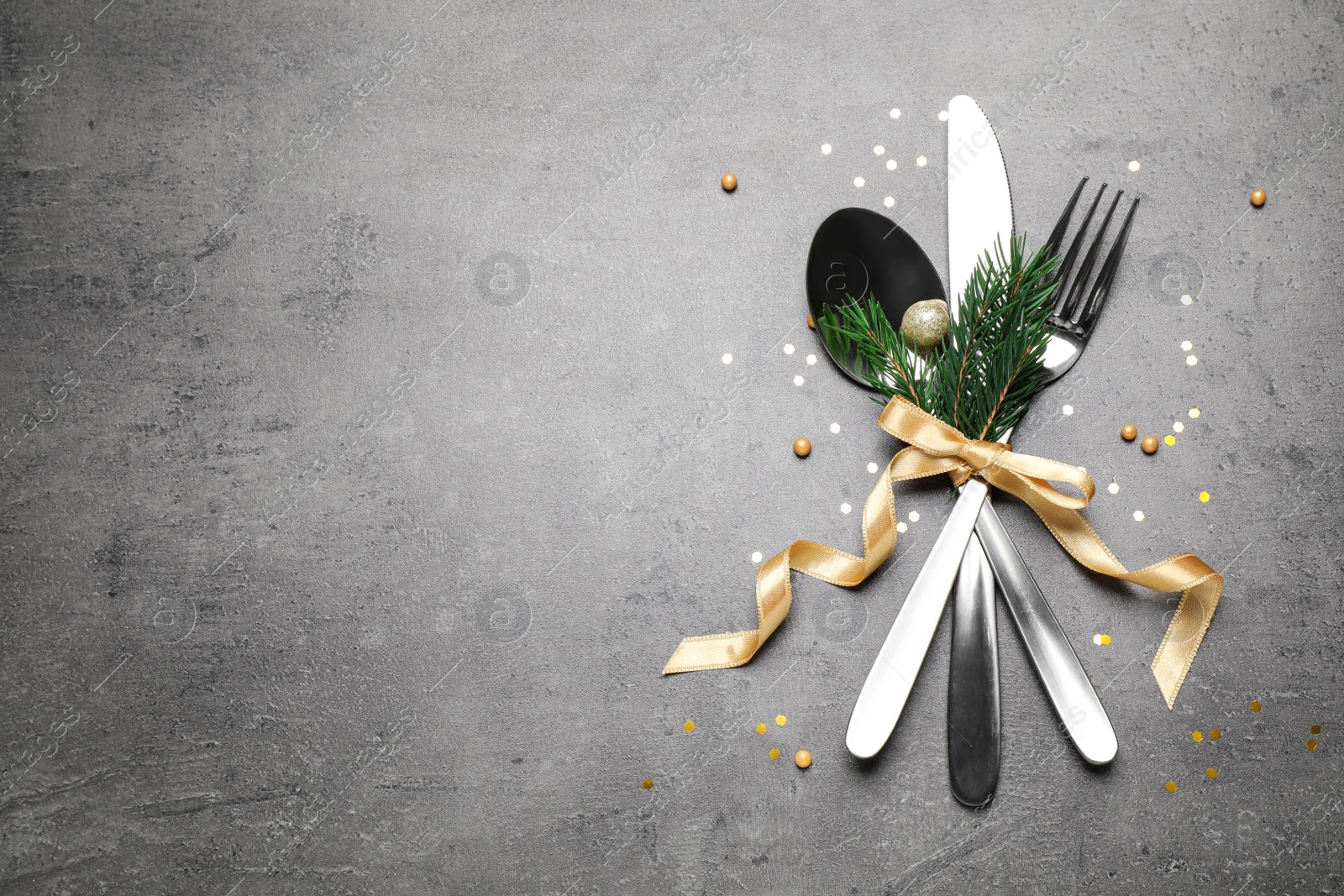 Photo of Cutlery set on grey table, flat lay. Space for text