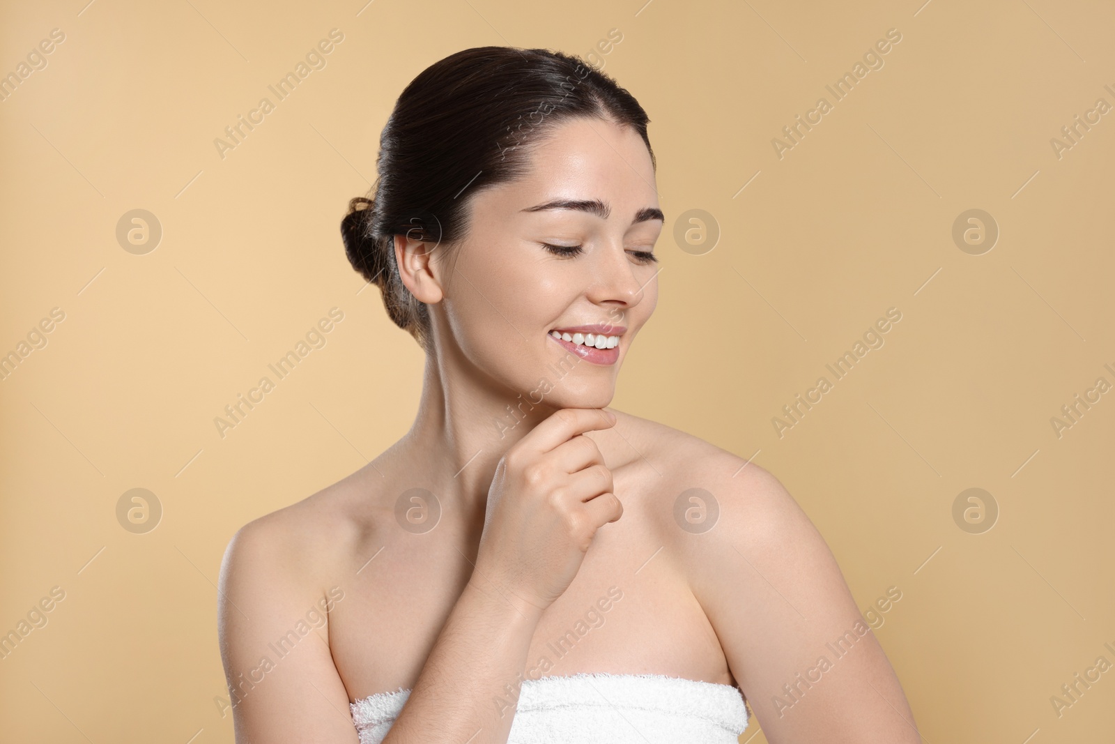 Photo of Portrait of attractive young woman on beige background. Spa treatment