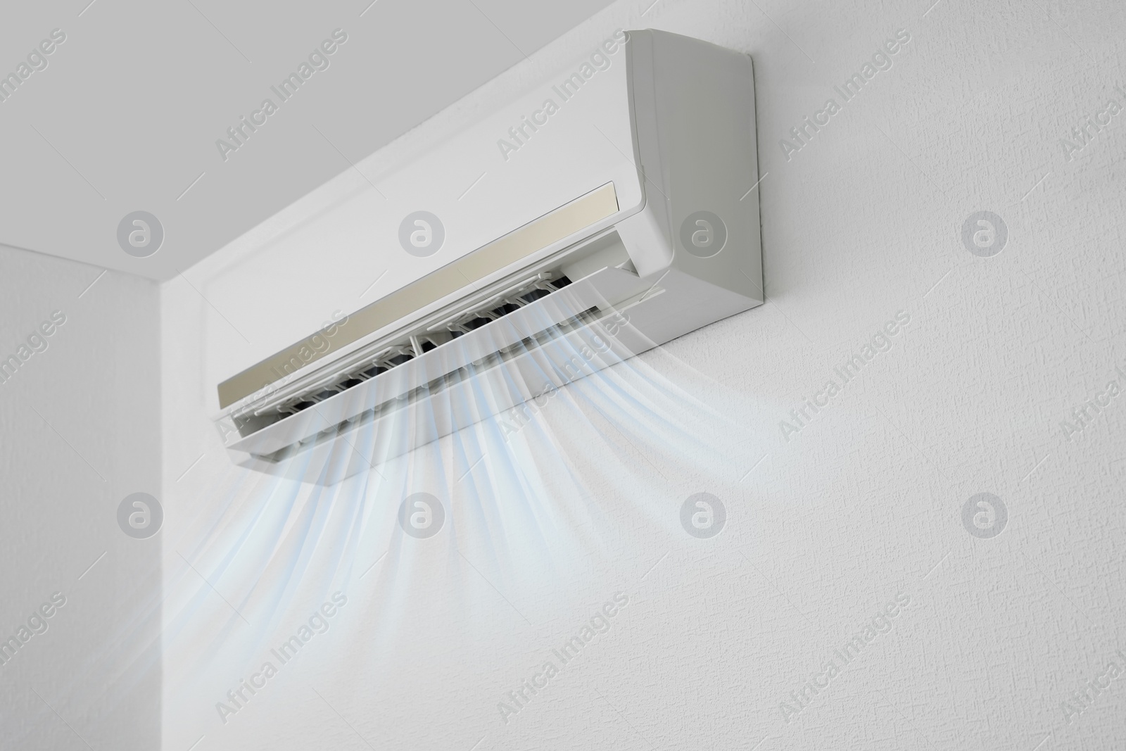 Image of Modern air conditioner on white wall indoors