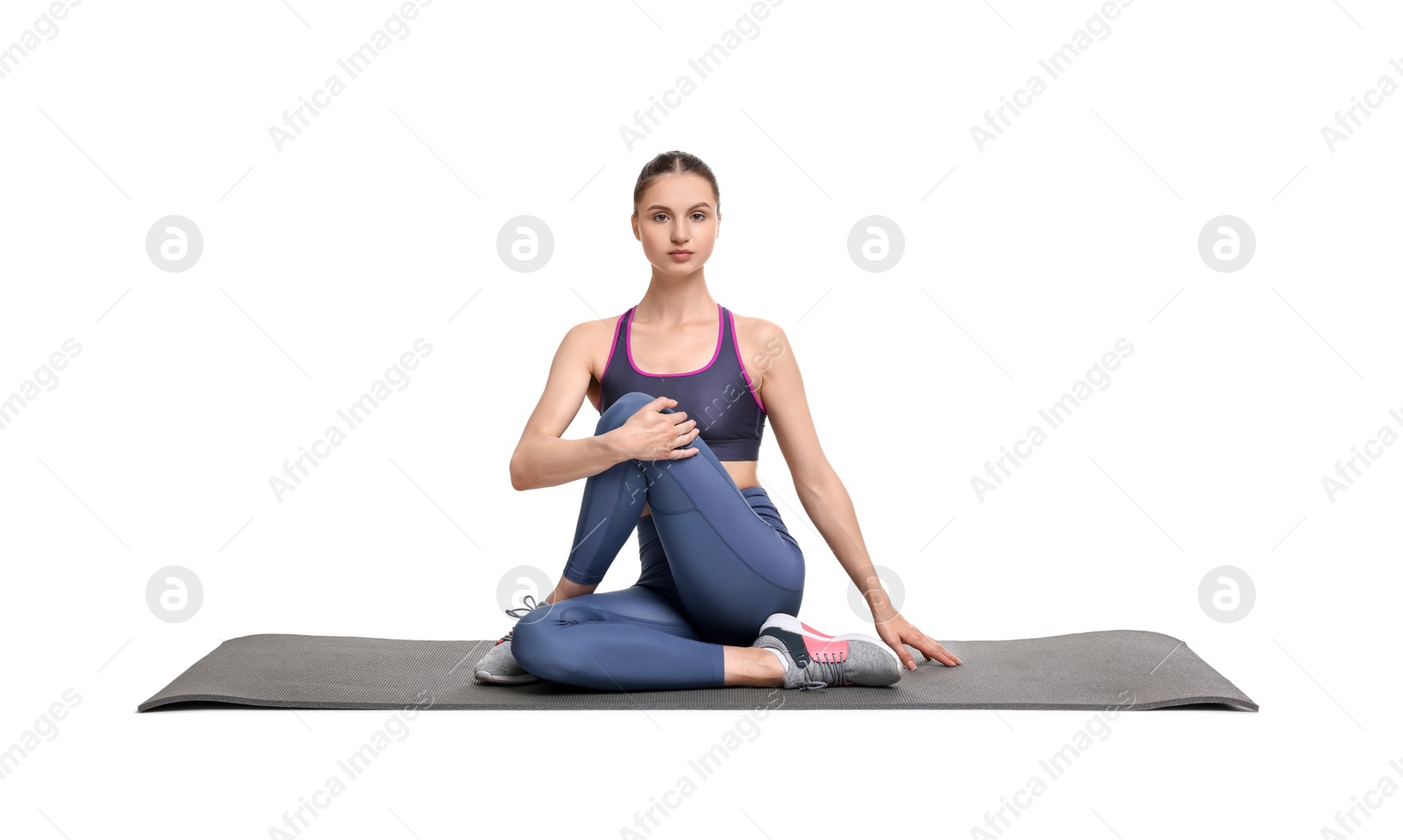 Photo of Yoga workout. Young woman stretching on white background