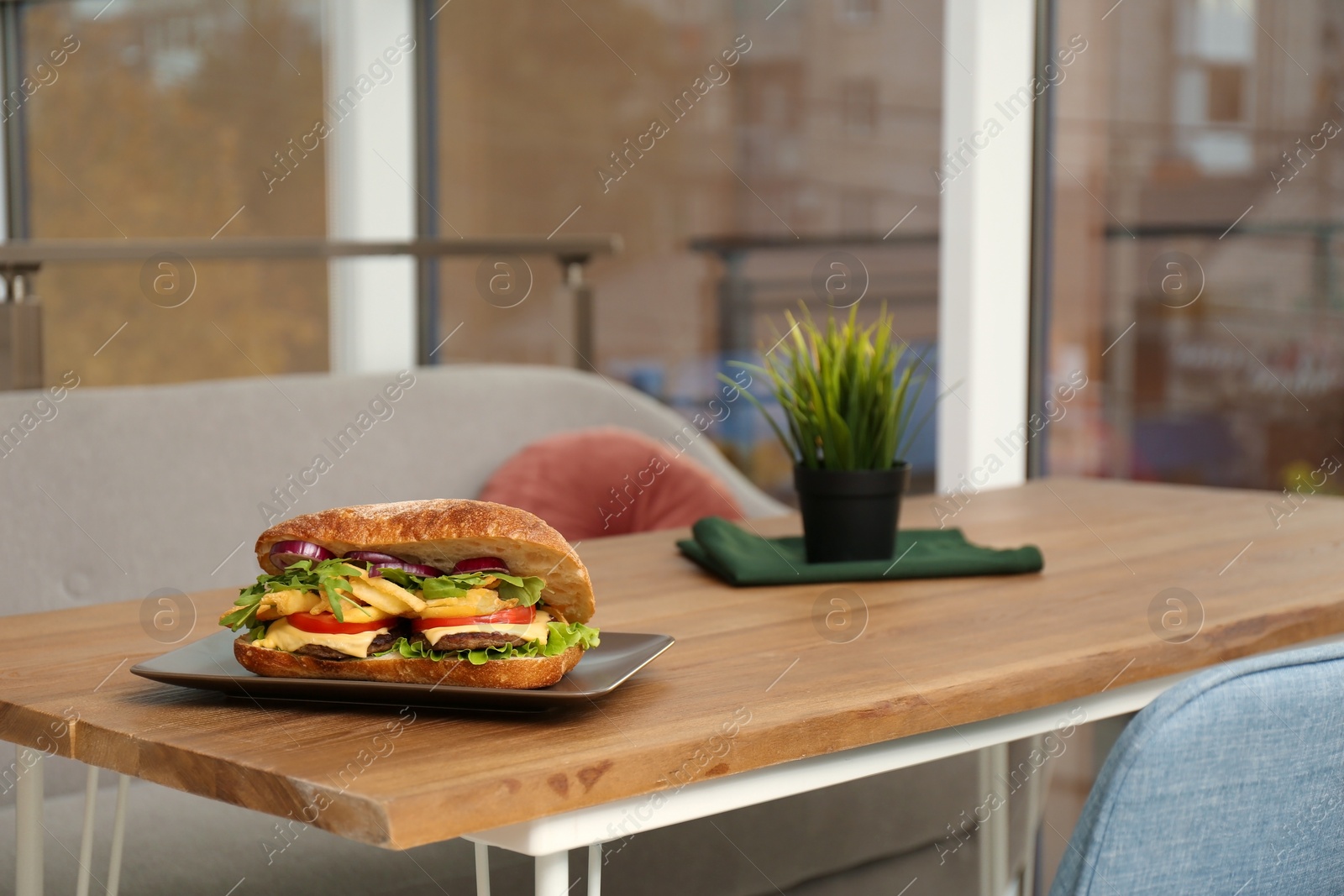 Photo of Plate with yummy sandwich on table in cafe