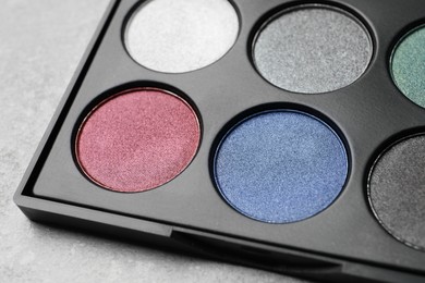 Beautiful eye shadow palette on grey table, closeup