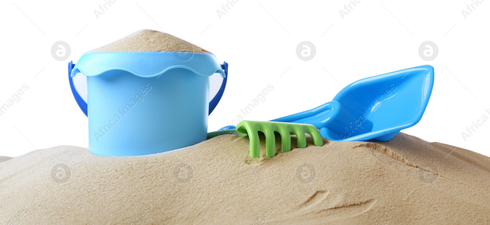 Photo of Plastic toy set with shovel on pile of sand