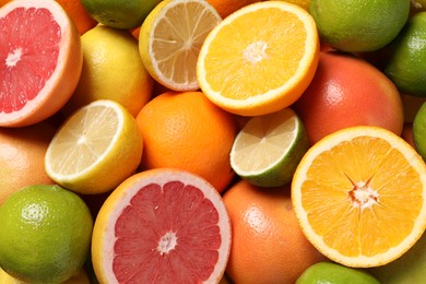 Photo of Different fresh citrus fruits as background, top view