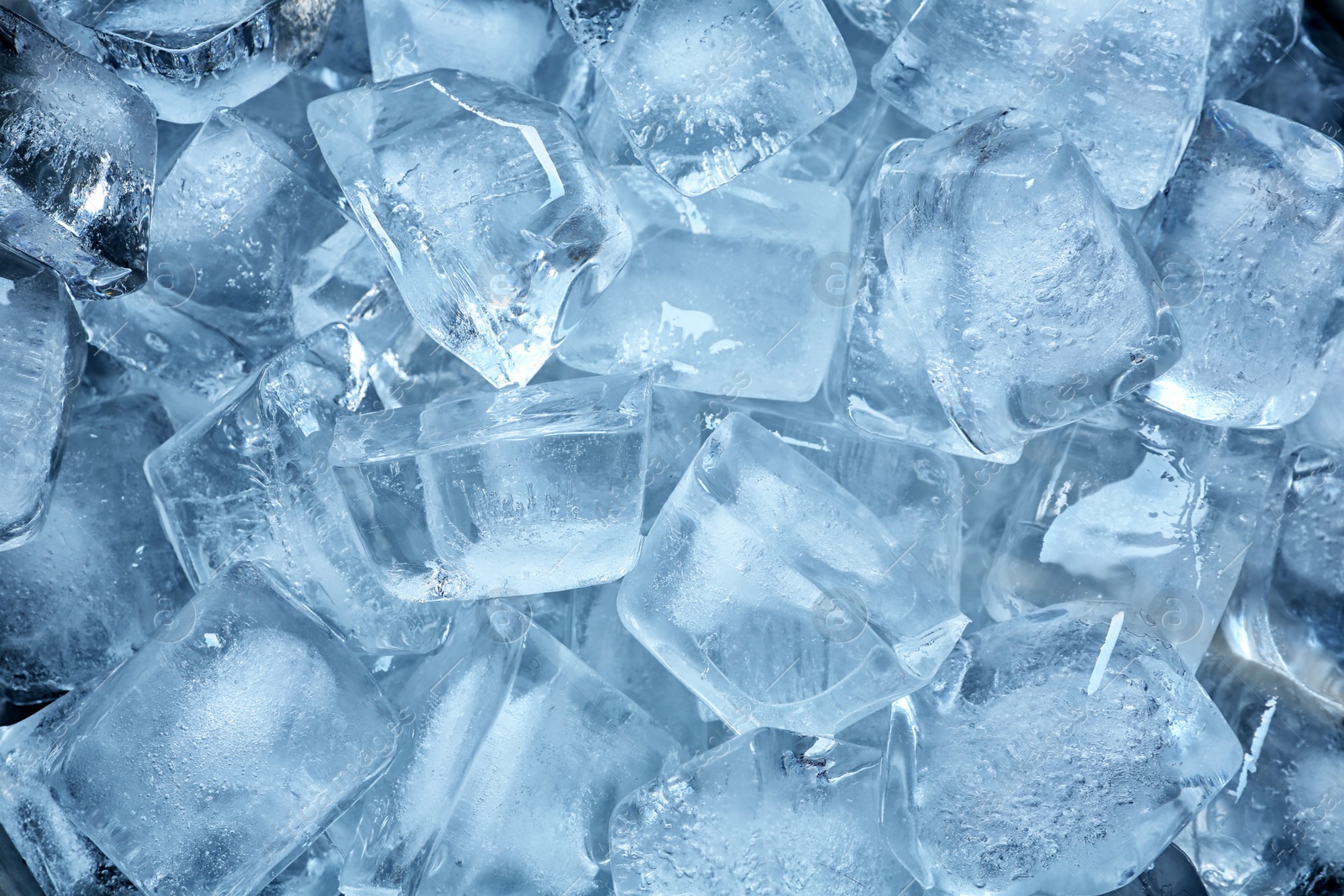 Photo of Many ice cubes on color background, top view