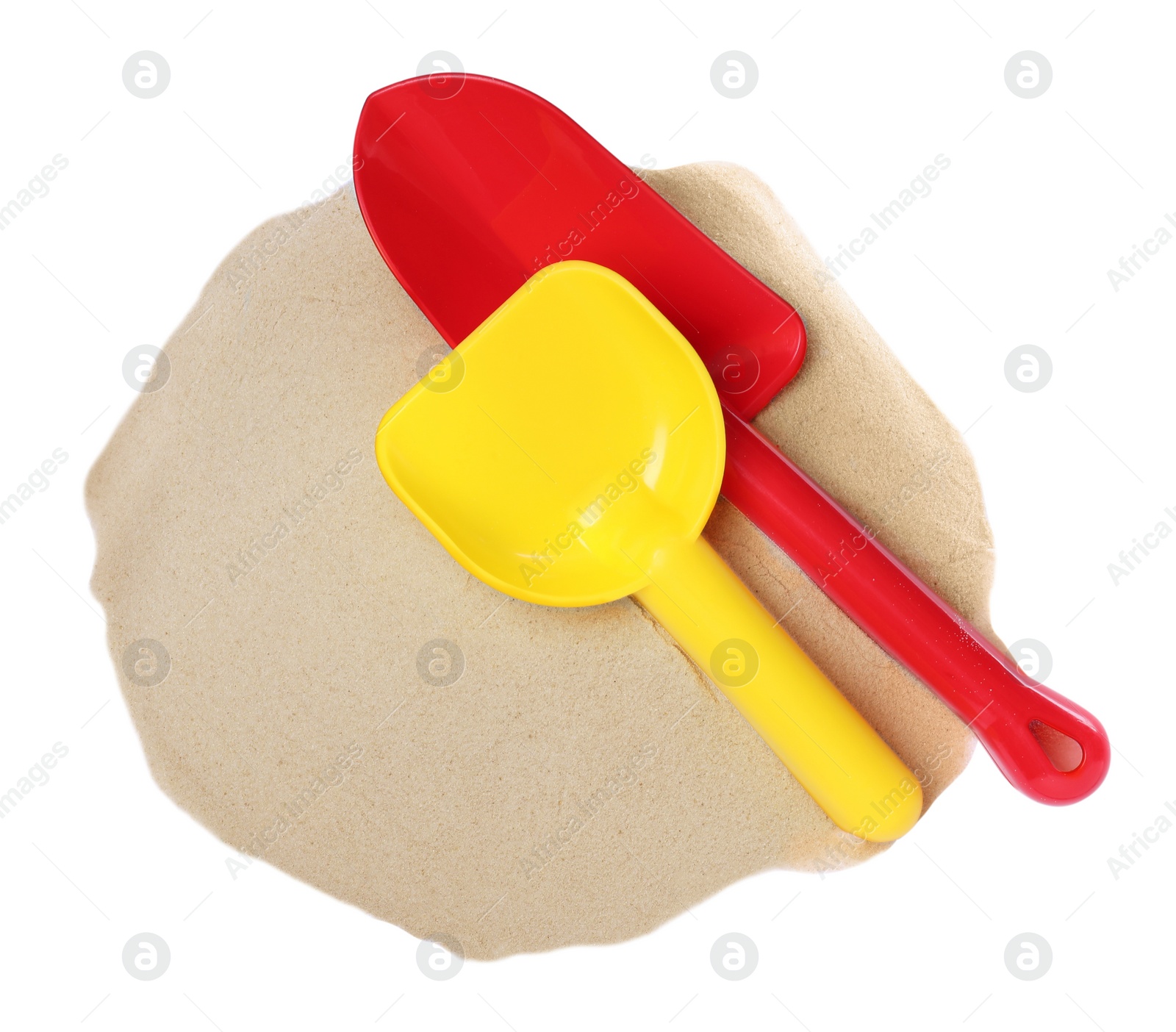 Photo of Plastic toy shovels and pile of sand on white background, top view
