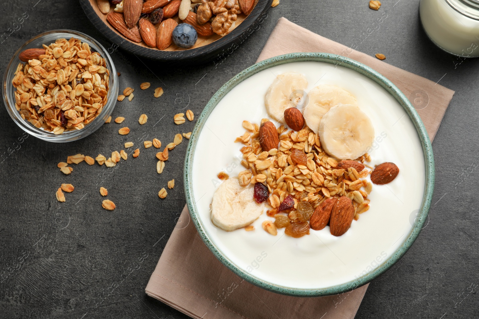 Photo of Tasty yogurt with banana and granola for breakfast on table, top view