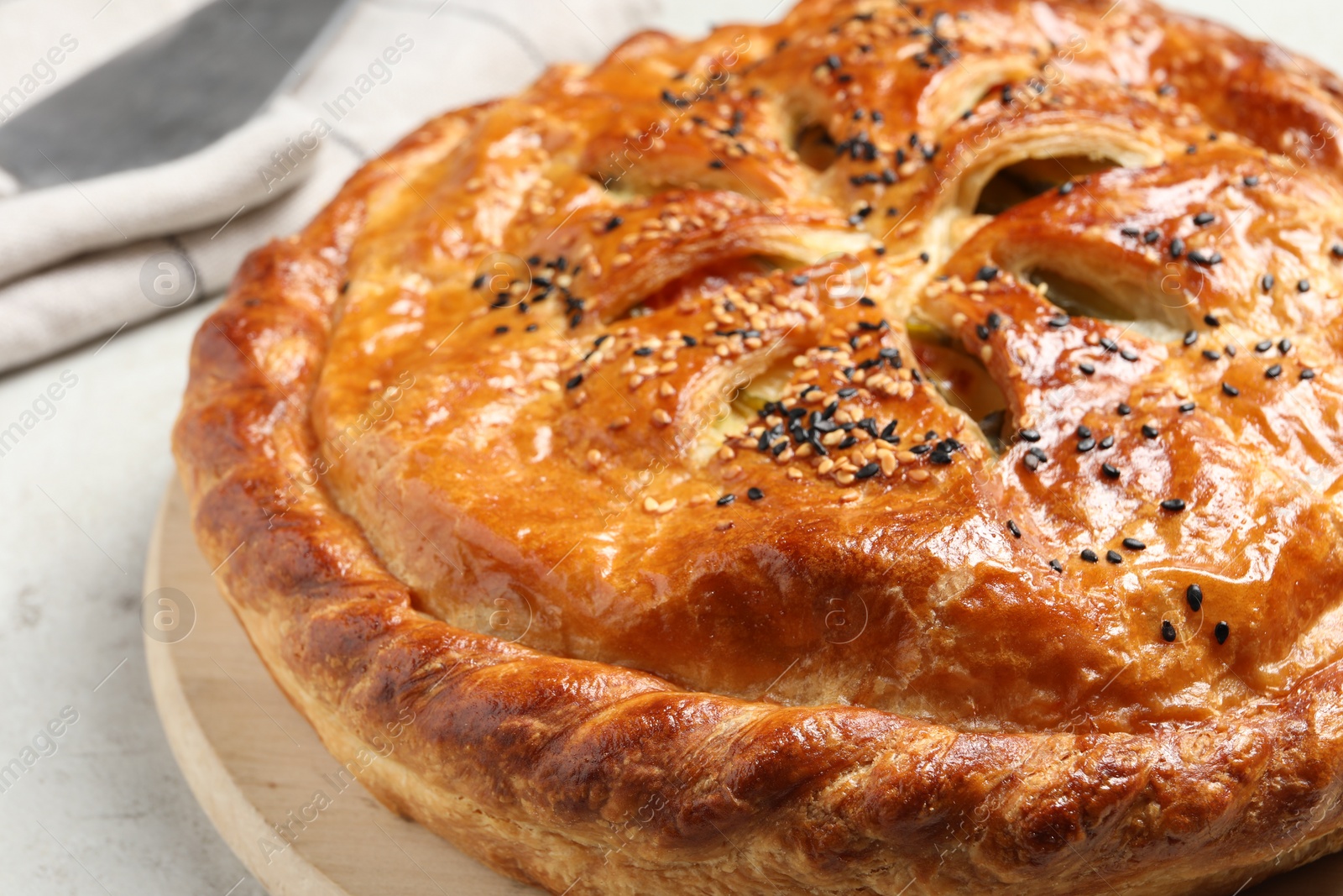 Photo of Tasty homemade pie with filling on light table, closeup