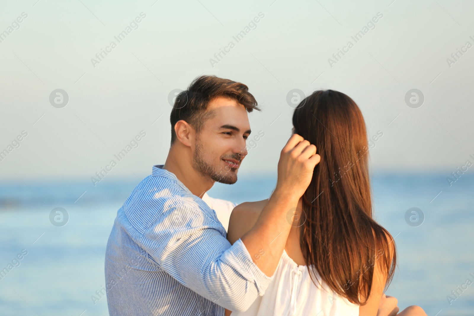 Photo of Happy young couple at beach on sunny day