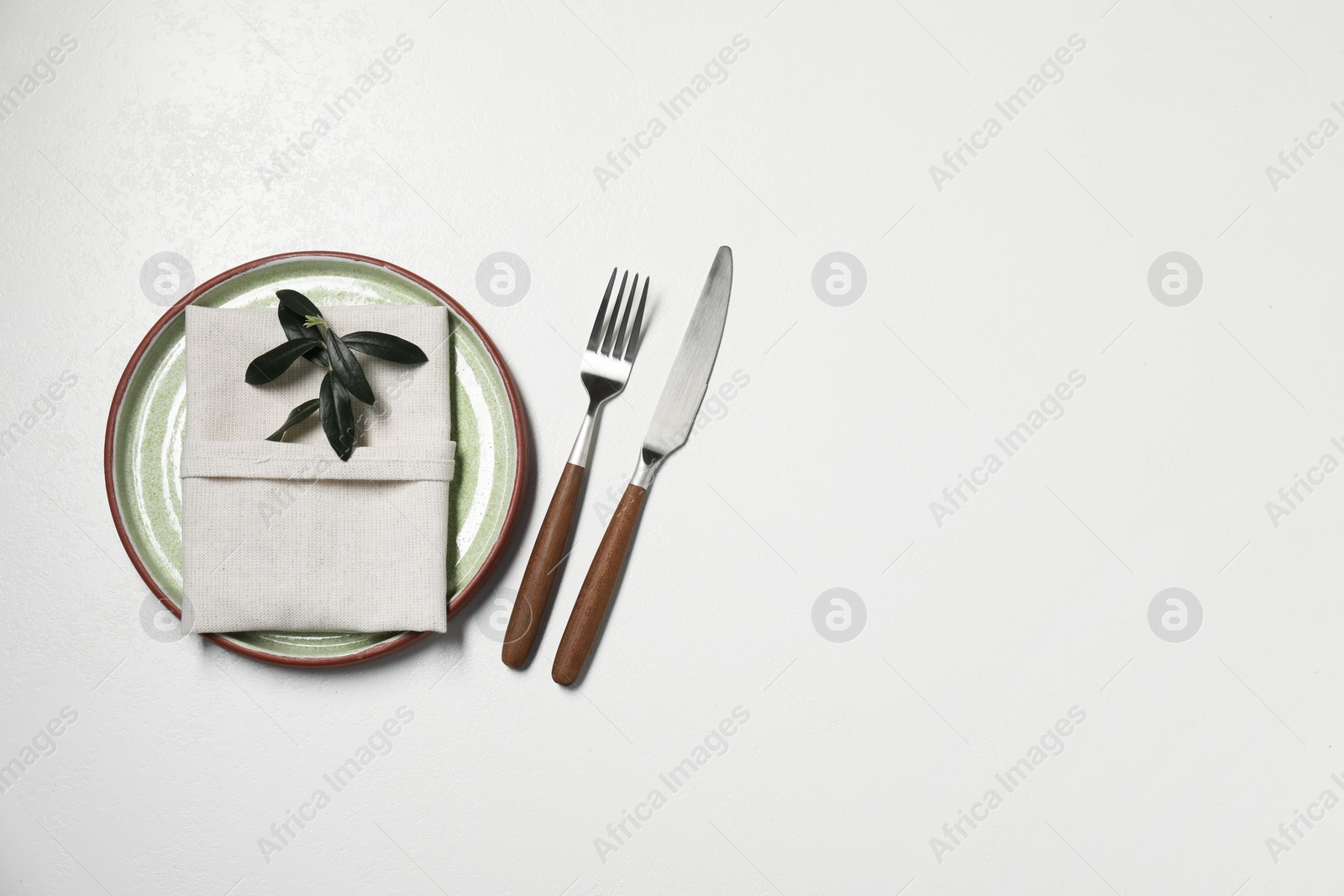 Photo of Stylish setting with elegant cutlery on white table, top view. Space for text