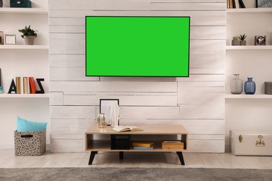 Image of Chroma key compositing. TV with mockup green screen in room. Mockup for design