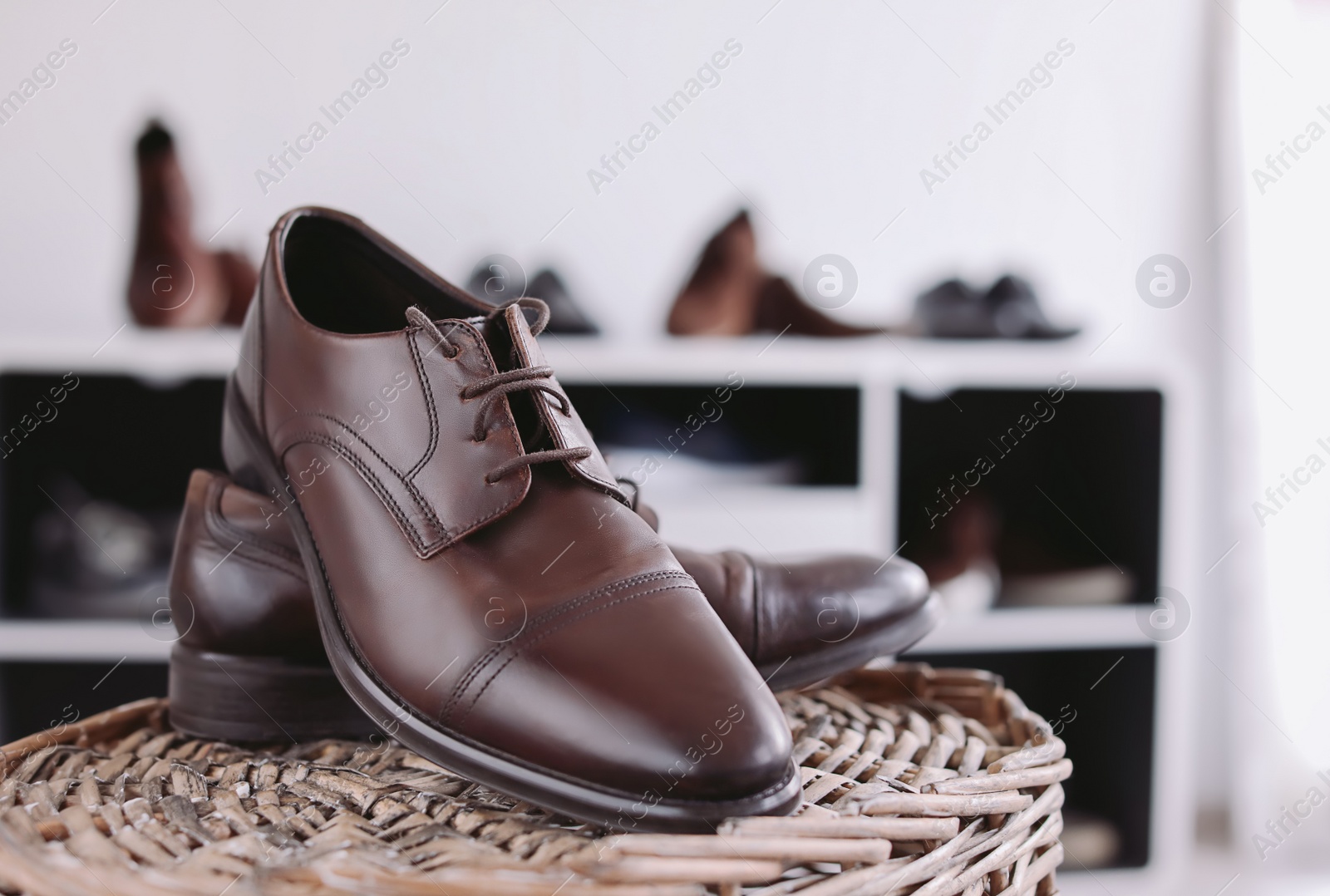 Photo of Male shoes on wicker stand in store